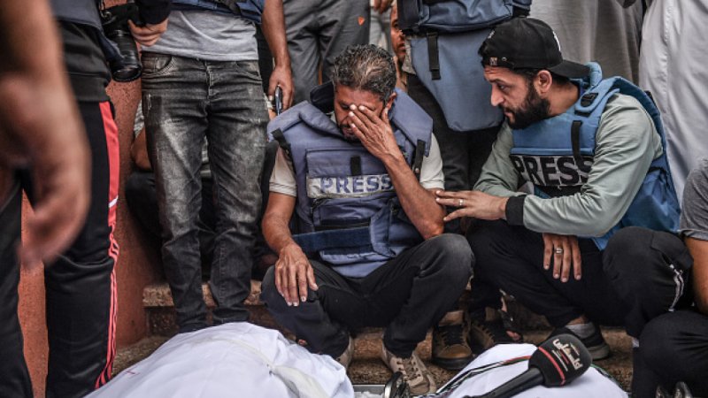 Gaza reporter rips off press vest on-air as colleague dies